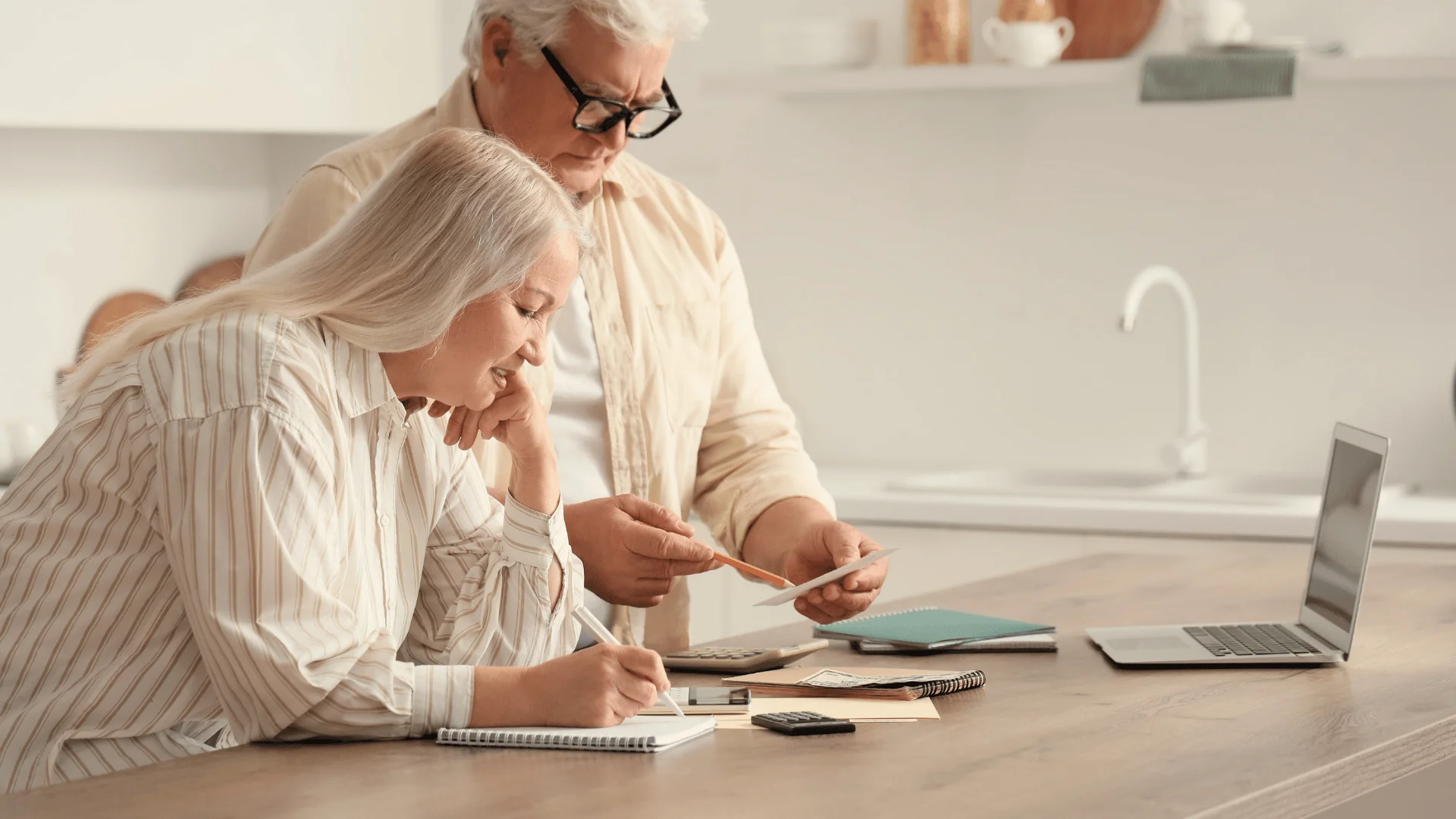 Homeowners reviewing a high water bill and household expenses